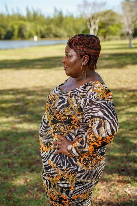 Bbw Big Black Beautiful Model Sitting On A Park Bench Outdoors Stock