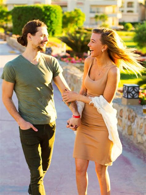 Young Beautiful Couple In Love Holding Hands Romantic Walking On