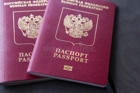 Two Russian Passports In Hand Russian Official Document On Wooden