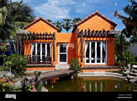 Orange paint house exterior. Thailand S. E. Asia Stock Photo - Alamy