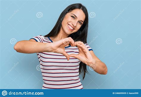 Young Hispanic Girl Wearing Casual Striped T Shirt Smiling In Love