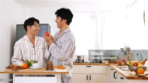 Happy Gay Couple Enjoy Breakfast In Kitchen Drinking Coffee Two Best Friends Lgbtq Relation