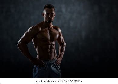 Male Muscular Athlete Sitting On Cube Stock Photo Edit Now