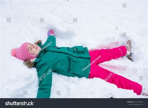 Happy Child Girl Lying On Snow Stock Photo 1901747062 | Shutterstock