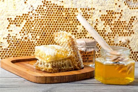 Jar Of Fresh Honey And Honeycombs On Gray Table Near Frame With