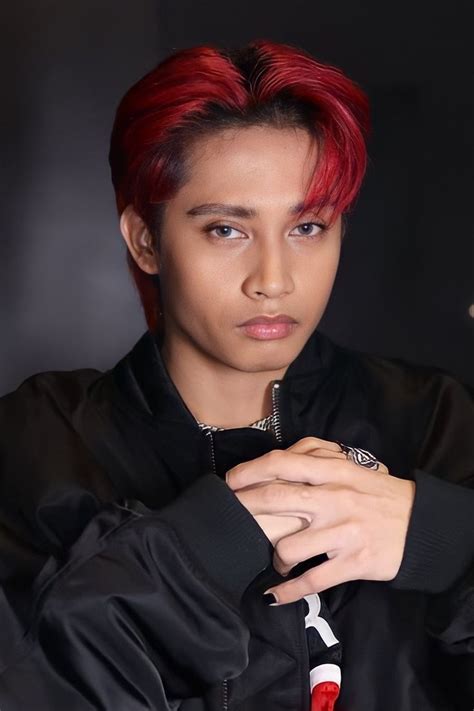 A Young Man With Red Hair Wearing A Black Jacket And Silver Ring On His