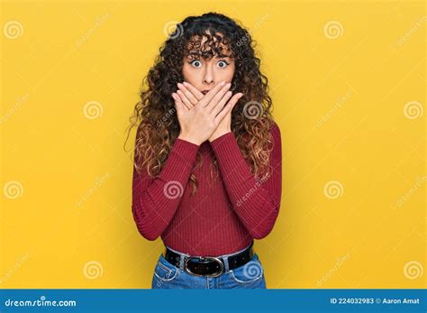 Young Hispanic Girl Wearing Casual Clothes Shocked Covering Mouth With