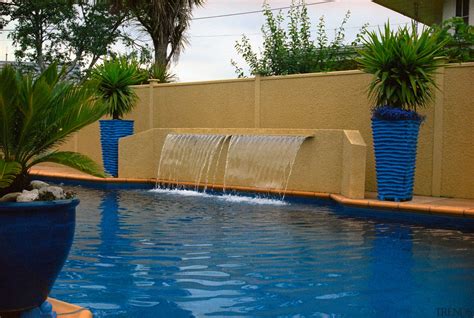 Blue outdoor pool with waterfall fe... - Gallery - 2 | Trends