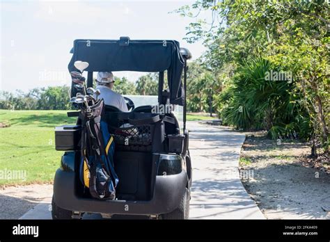 Golfer Driving A Golf Car Stock Photo Alamy