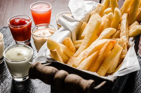 Premium Photo | French fries in basket with sauce dipping