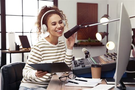 African American Woman Working As Radio Host In Modern Studio Stock