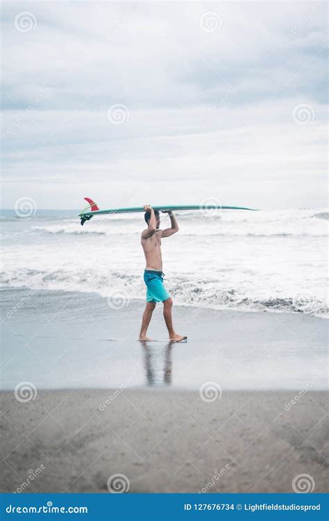 Surfer Carrying Surfboard On Head Stock Photo Image Of Male Sporting