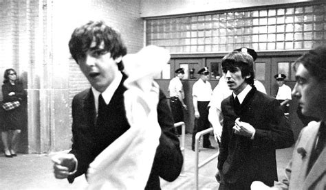 Black And White Photograph Of Men In Suits One Holding A Scarf Over