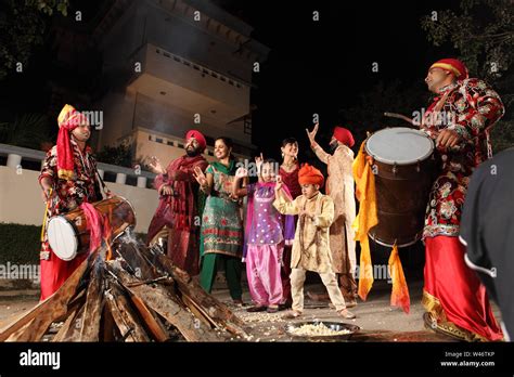 Family celebrating Lohri festival, Punjab, India Stock Photo - Alamy