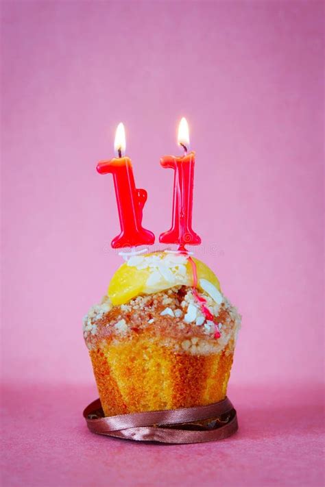 Birthday Of Eleven Years Cupcake With White Burning Candle In The Form