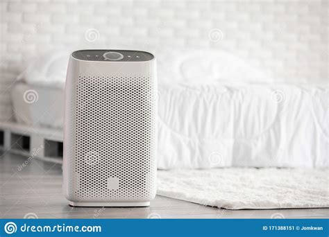 Air Purifier In Cozy White Bed Room For Filter And Cleaning Removing