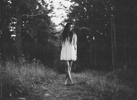 "A Beautiful Young Woman Walks Alone In A Dark Woods" by Stocksy ...