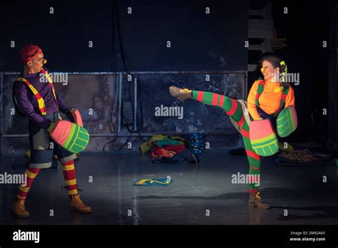 Young theater actors in a clown play in colorful costumes during a