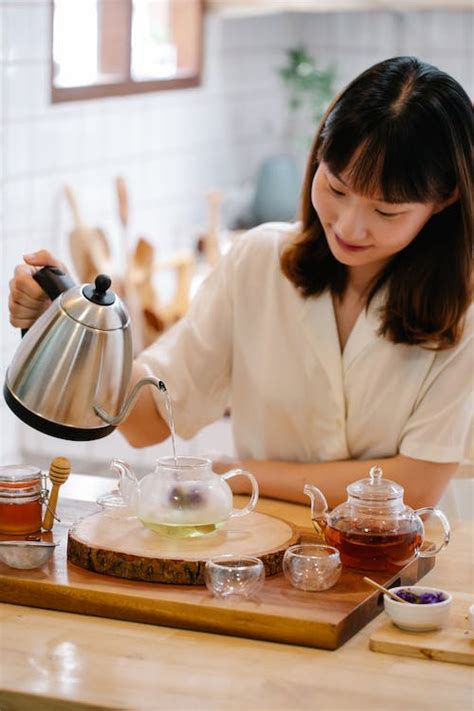 Woman Pouring Boiling Water Into Pot · Free Stock Photo