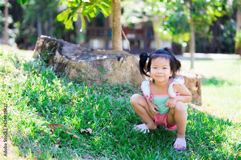 Cute Girl Aged 3 4 Years Old Is Having Fun In The Green Nature Park