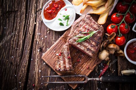 Beef Steak On Wooden Table Stock Photo By Kesu