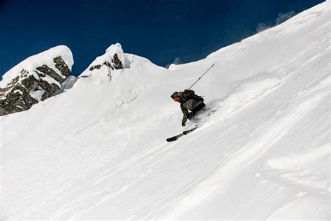 Great View On Male Skier Slides Down The Snow Covered Slope Freeride