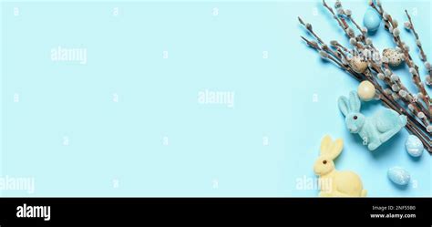 Easter Eggs Toy Bunnies And Pussy Willow Branches On Light Blue Background With Space For Text