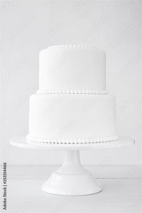 White wedding cake blank on a white background. Simple minimalism. Stock Photo | Adobe Stock