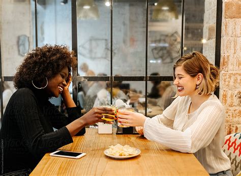 Two Girlfriends In A Restaurant By Stocksy Contributor Marco Govel