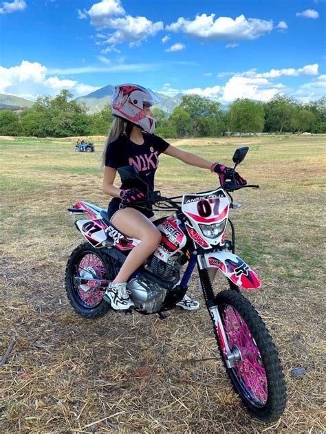 A Girl Sitting On Top Of A Dirt Bike