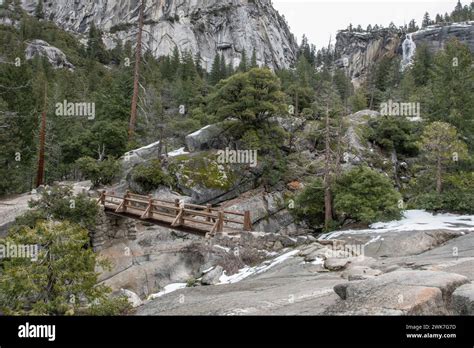 A Wooden Bridge Over A Rocky Chasm In The Sierra Nevada Mountains Of