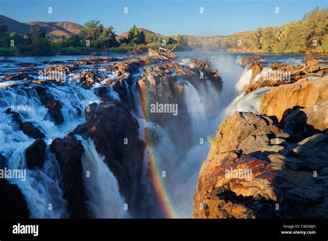 A Rainbow Over The Epupa Falls On The Kunene River Namibia Stock Photo