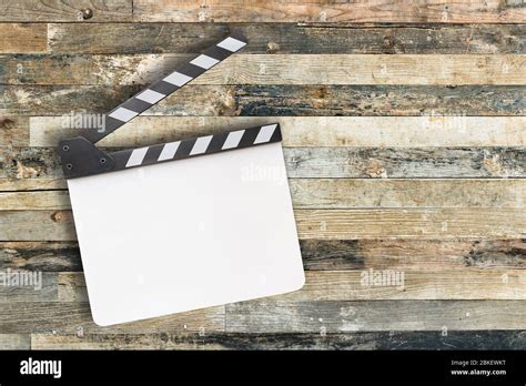 White movie clapper board on wooden background Stock Photo - Alamy