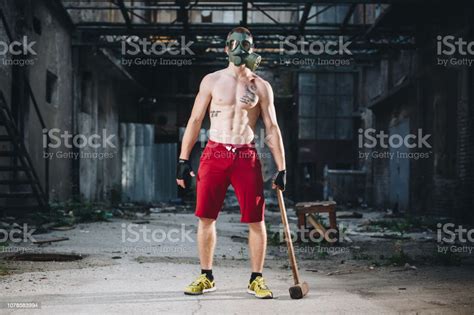 Strong Man With A Gas Mask And A Sledge Hammer Stock Photo Download