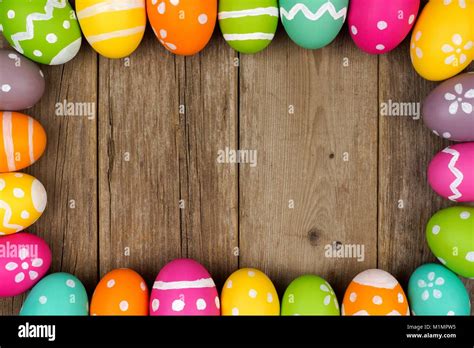 Colorful Easter egg frame against a rustic wood background Stock Photo ...