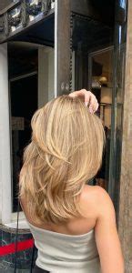 Exploring Chic Haircuts And Hair Trends Sleek Dark Blonde Layers