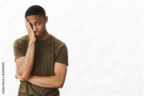 Portrait Of Man Feeling Embarrassed Making Facepalm Gesture Putting Hand To Half Of Face Peeking