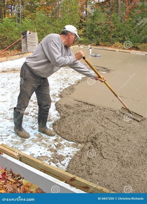 Man Raking Concrete Stock Photo - Image: 6847200