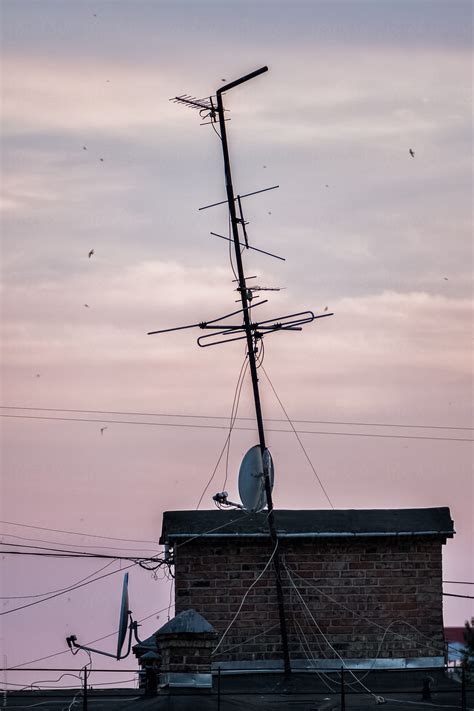 "Old Antenna On A House Rooftop" by Stocksy Contributor "Ilya" - Stocksy