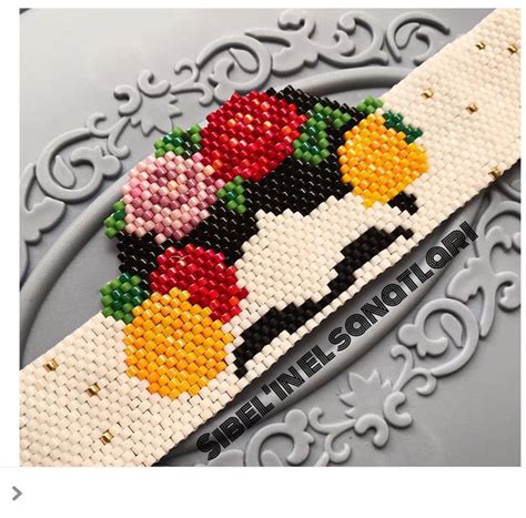 A Cross Stitch Pattern With Flowers On The Front And Back Of It