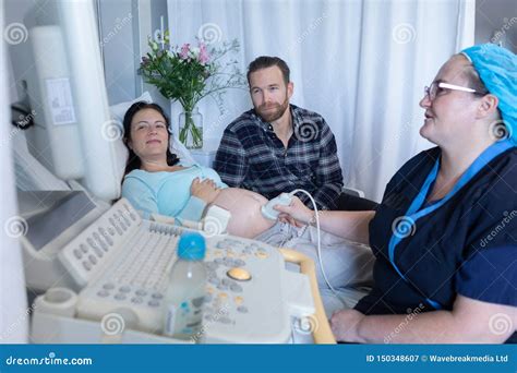 Doctor Doing Ultrasound Scan For Pregnant Woman In Hospital Stock Image