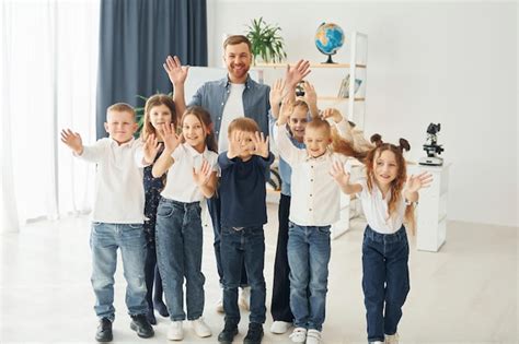 Premium Photo | Showing hello gestures group of children students in ...