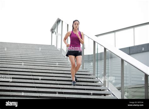 Young Woman Running Down Stairs For Exercise Stock Photo Alamy