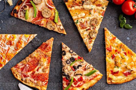 Variety of pizza slices top view on dark background 16231488 Stock ...