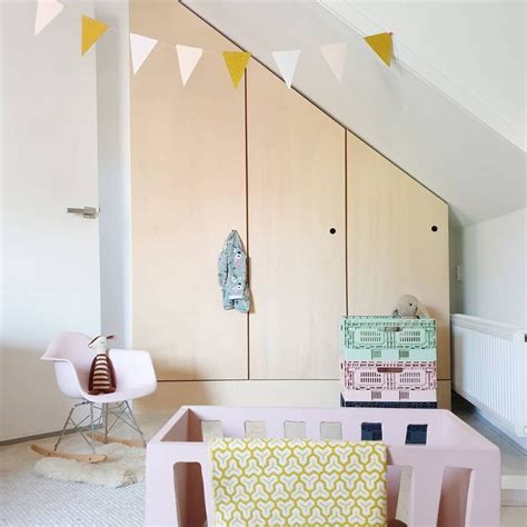 A Living Room With Pink Furniture And Yellow Accents On The Walls