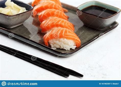 Close Up Of Sashimi Sushi Set With Chopsticks And Soy Sushi Roll With