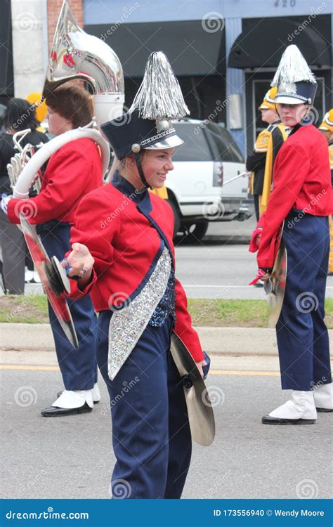 Young White Female Cymbal Player In A Marching Band In The Cherry