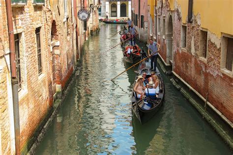 Free Stock Photo of Tourists On Gondolas In Street Between Buildings