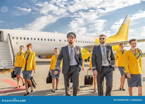 Pilots And Flight Attendants Walking Down Airfield Stock Photo Image