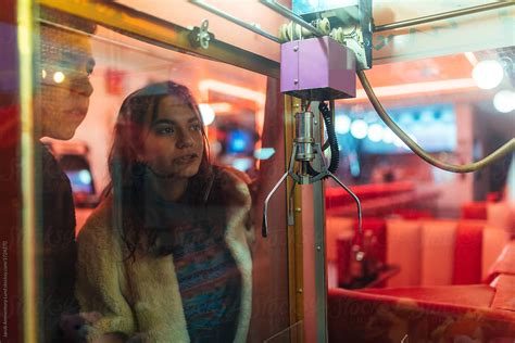 Couple Playing Claw Game At Arcade Center By Stocksy Contributor